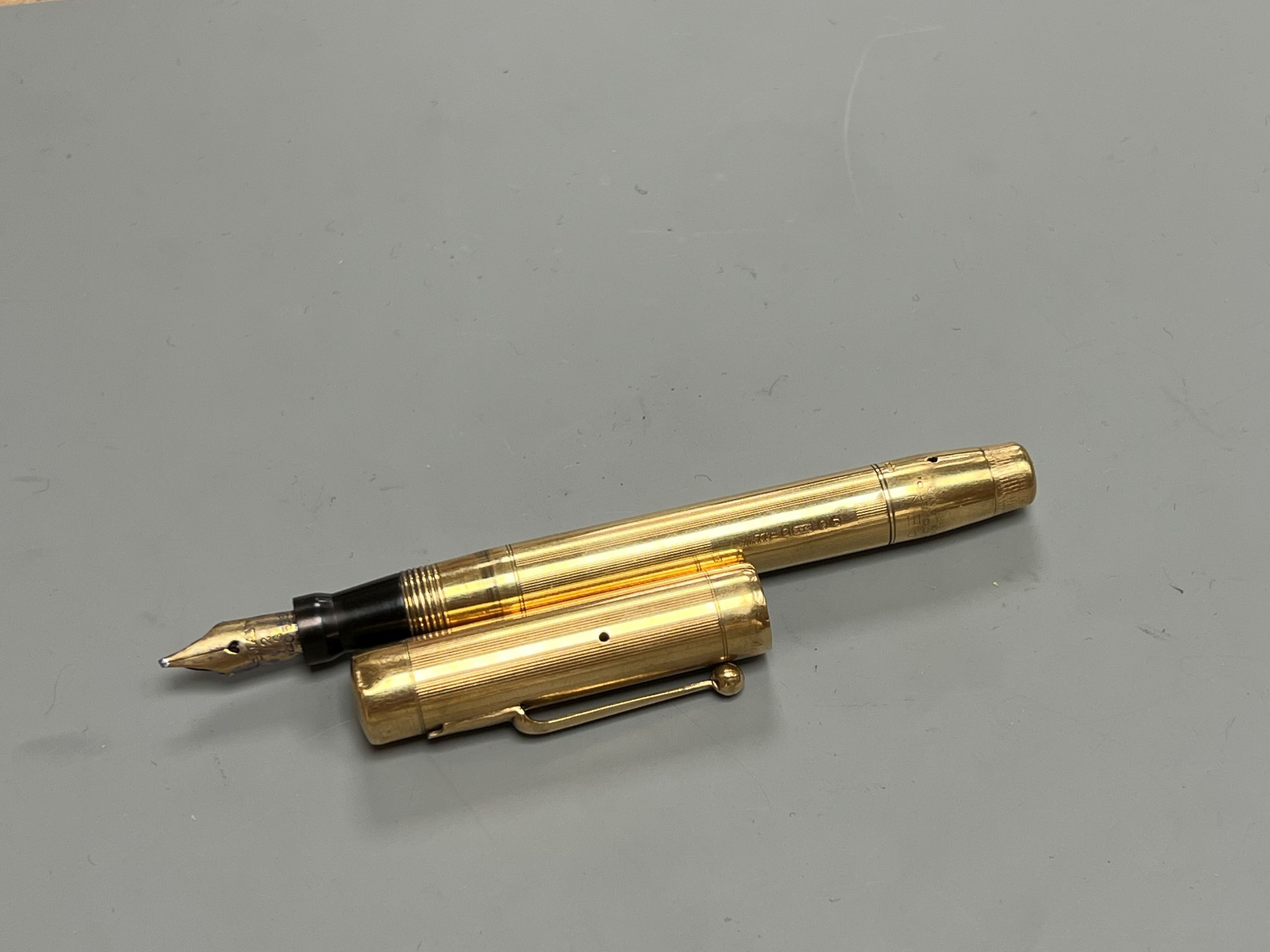 A Swan engine turned 9ct gold fountain pen